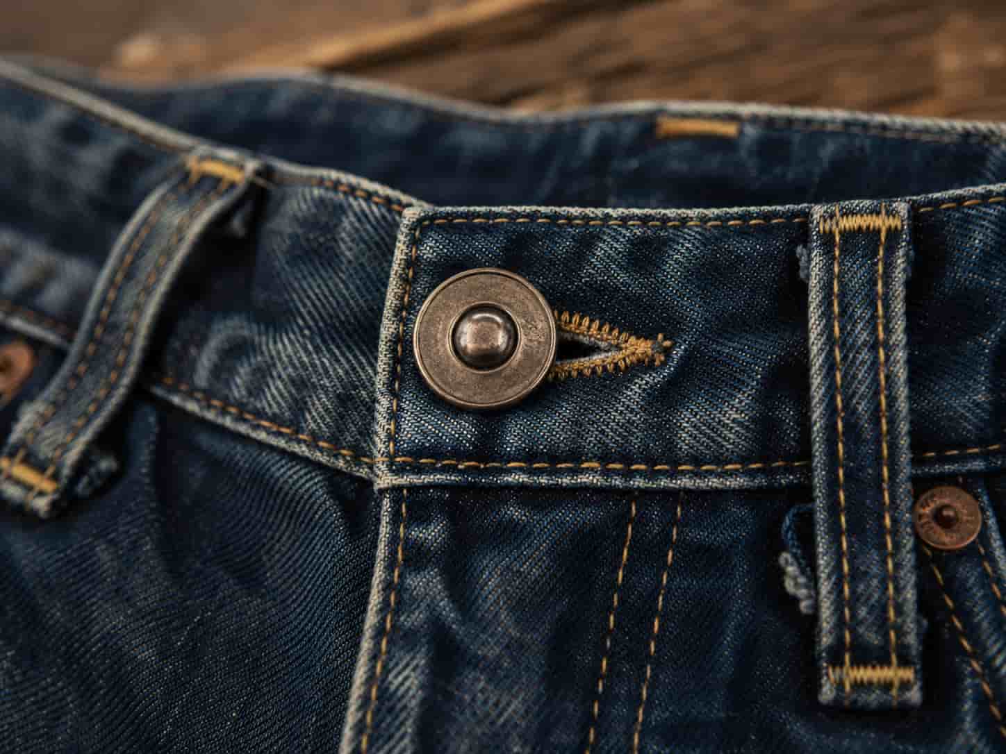 jean buttons，Denim jeans button showing fastening function and classic workwear heritage